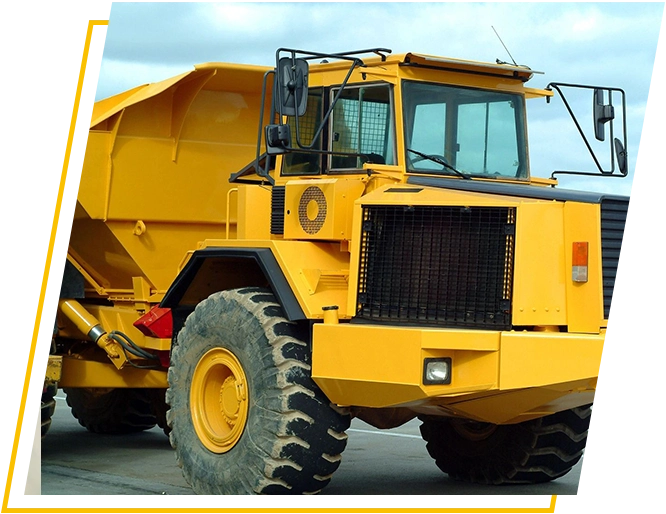 A yellow dump truck parked on the side of a road.